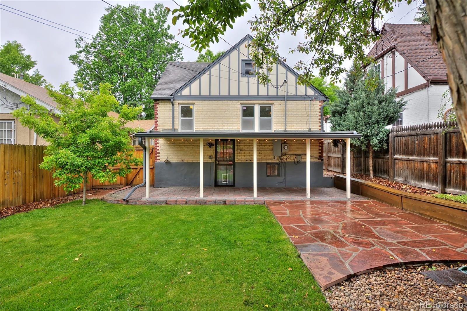 1674 Cherry Street Denver, CO 80220 - Photo 20 of 31 a view of a house with a yard and sitting area