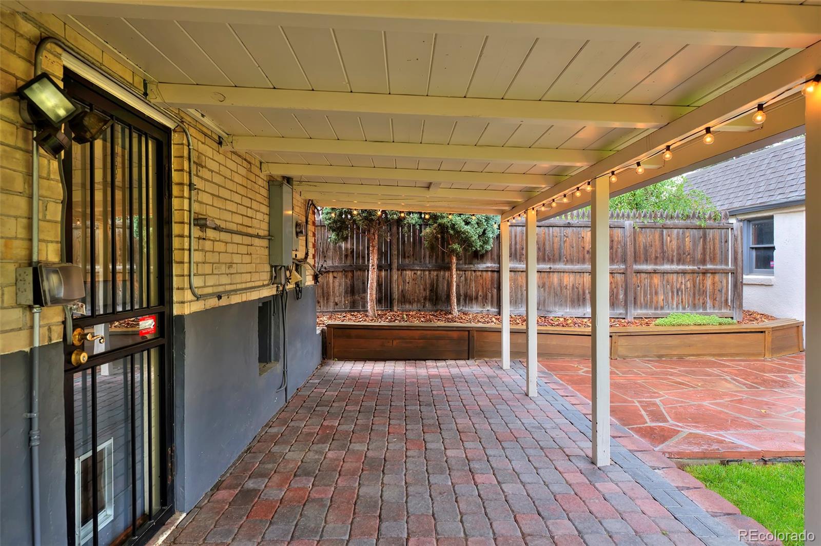 1674 Cherry Street Denver, CO 80220 - Photo 23 of 31 a view of a porch with wooden floor and iron stairs