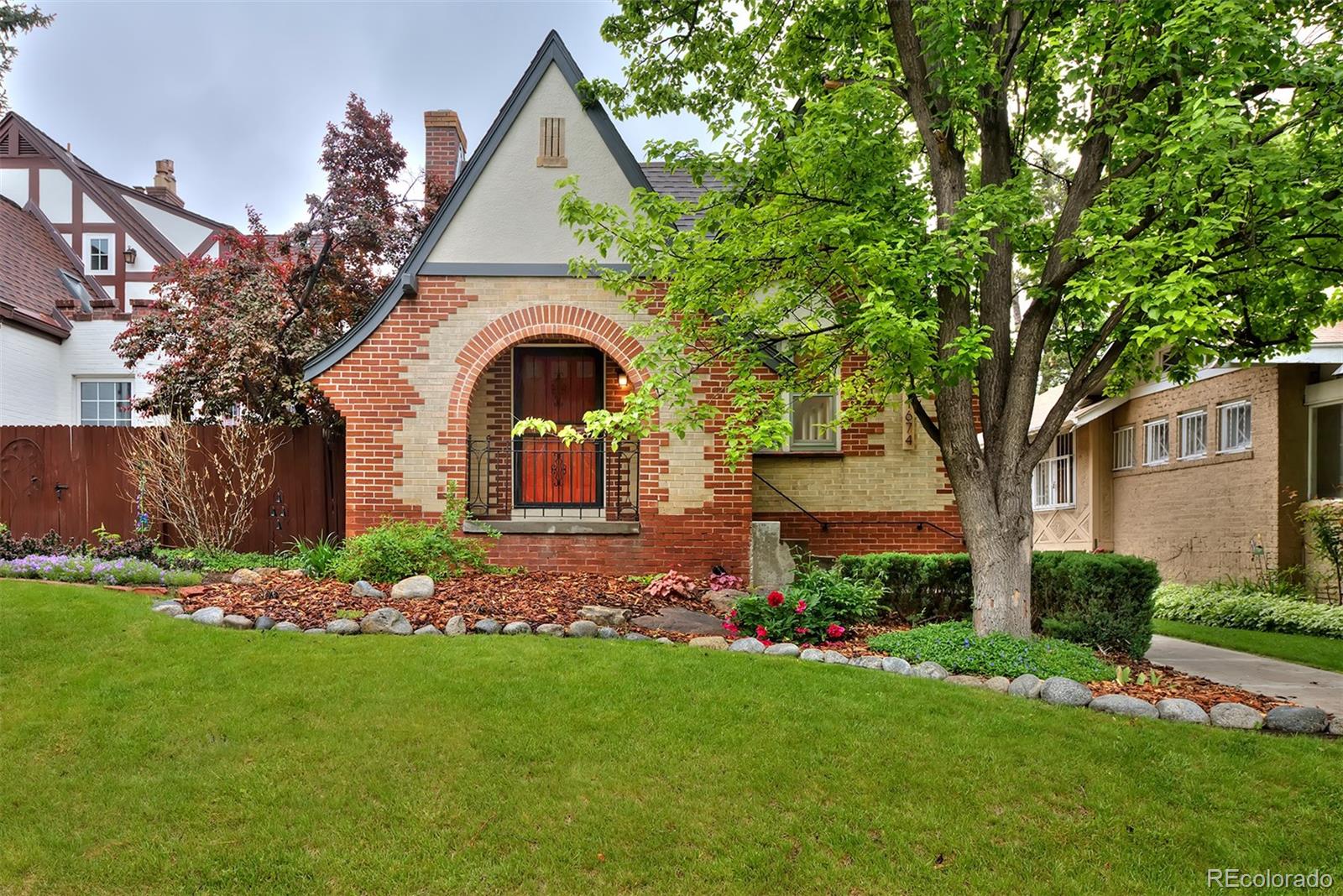 1674 Cherry Street Denver, CO 80220 - Photo 26 of 31 a front view of a house with garden