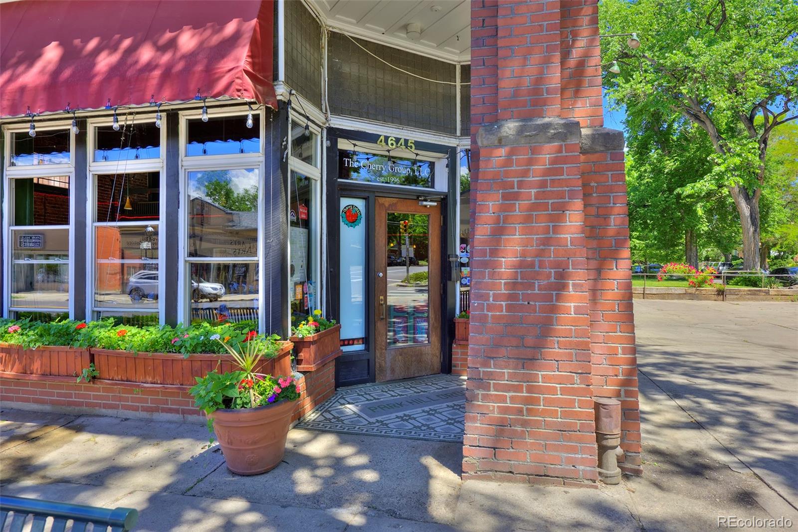 1674 Cherry Street Denver, CO 80220 - Photo 28 of 31 a front view of a building with a potted plant