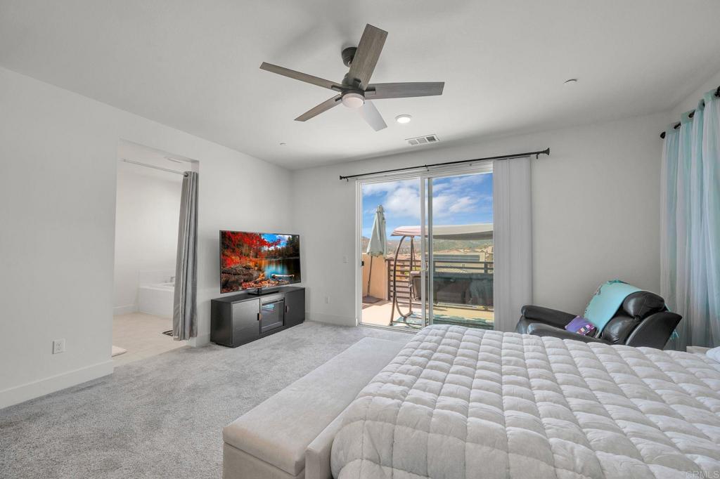 35374 Orchard Trail Fallbrook, CA 92028 - Photo 15 of 33 a bedroom with a bed and a large window
