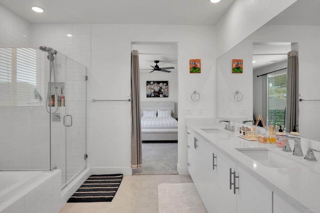35374 Orchard Trail Fallbrook, CA 92028 - Photo 16 of 33 a spacious bathroom with a double vanity sink a mirror and a shower
