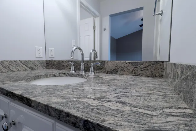 a view of a granite countertop sink and a granite counter top