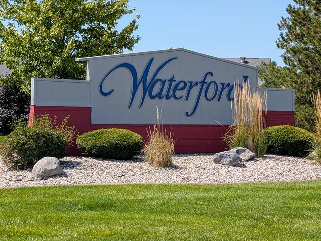 a wooden bench sitting in front of a building