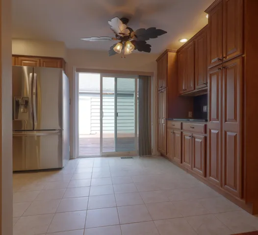 a kitchen with stainless steel appliances granite countertop a refrigerator a sink a stove and a cabinets