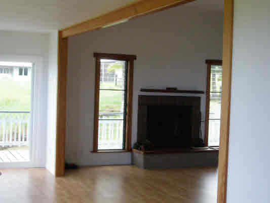 1939 Kaiwiki Road Hilo, HI 96720 - Photo 11 of 16 a living room with a fireplace and a window