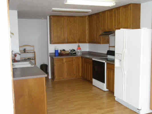 1939 Kaiwiki Road Hilo, HI 96720 - Photo 14 of 16 a kitchen with a sink a stove and a refrigerator