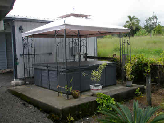 1939 Kaiwiki Road Hilo, HI 96720 - Photo 10 of 16 a view of a patio with table and chairs under an umbrella
