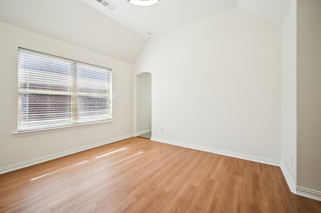 2029 Temperate Drive Allen, TX 75013 - Photo 24 of 40 a view of an empty room with wooden floor and a window