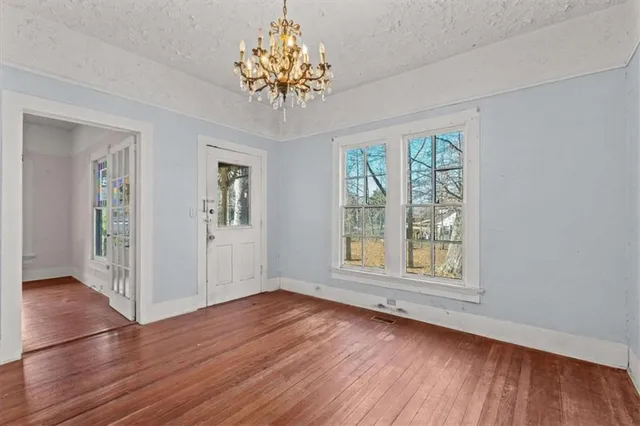 a kitchen with stainless steel appliances a sink cabinets and wooden floor