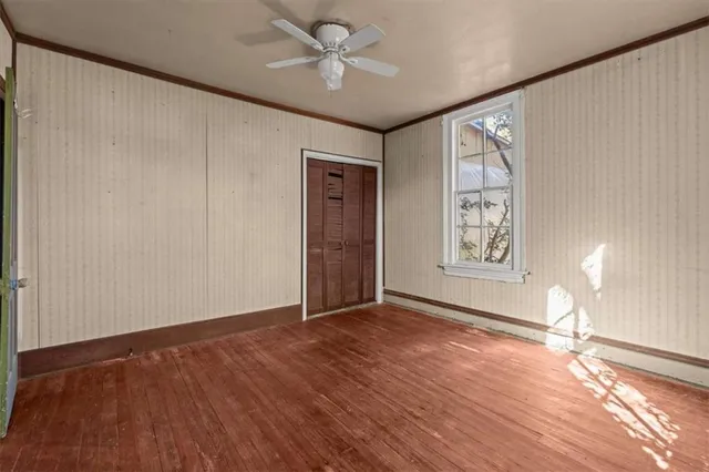 a view of an empty room with a fireplace and a window