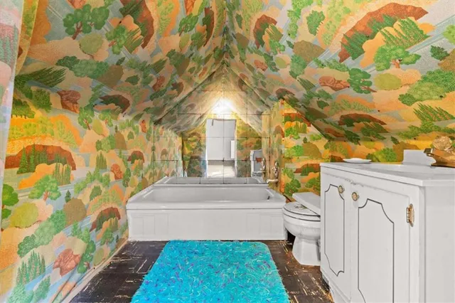 a view of a livingroom with a fireplace and a hallway