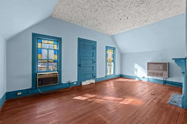 a view of a room with wooden floors