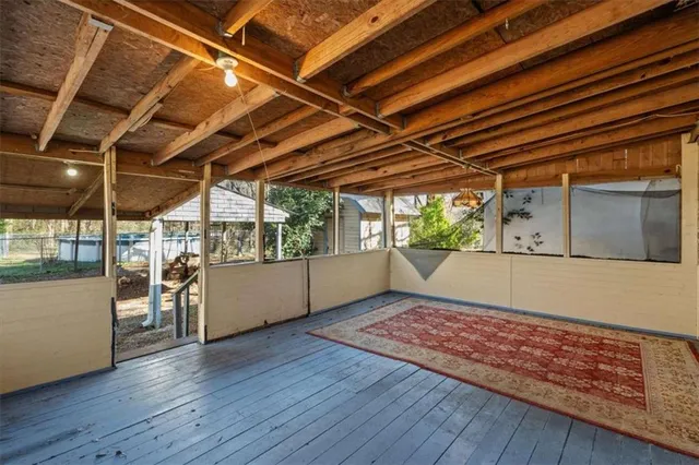 a view of a backyard with table and chairs under an umbrella
