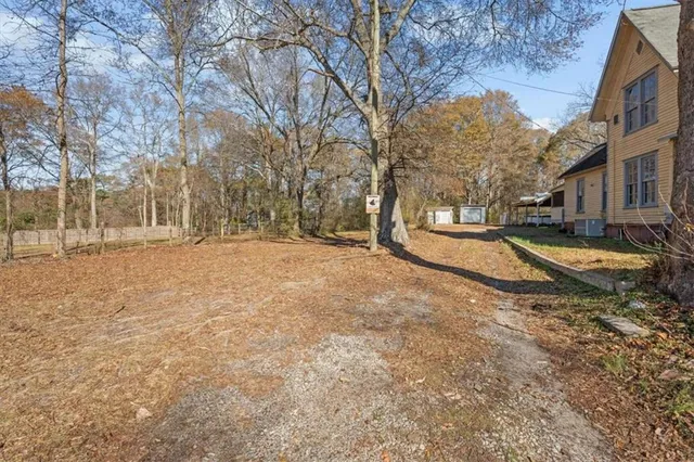 a view of yard with wooden fence