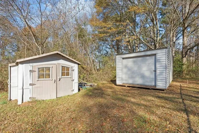 a view of a yard with plants and trees