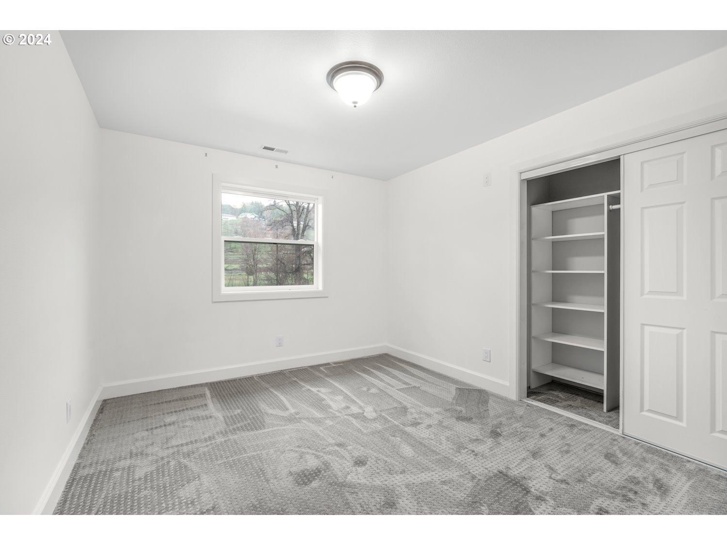 311 Washington Street Lyle, WA 98635 - Photo 20 of 29 an empty room with a window and closet