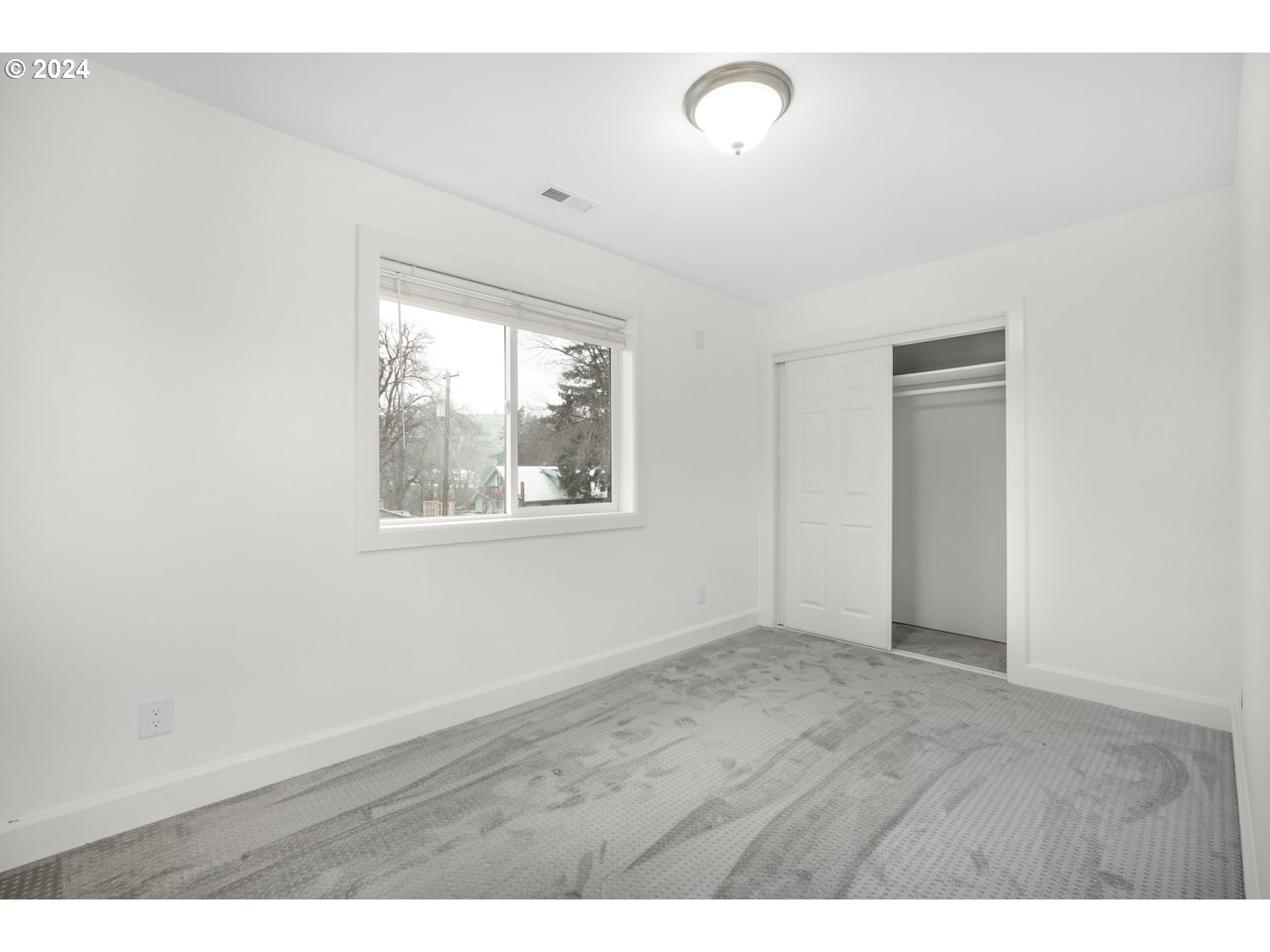 311 Washington Street Lyle, WA 98635 - Photo 21 of 29 a view of an empty room with wooden floor and a window