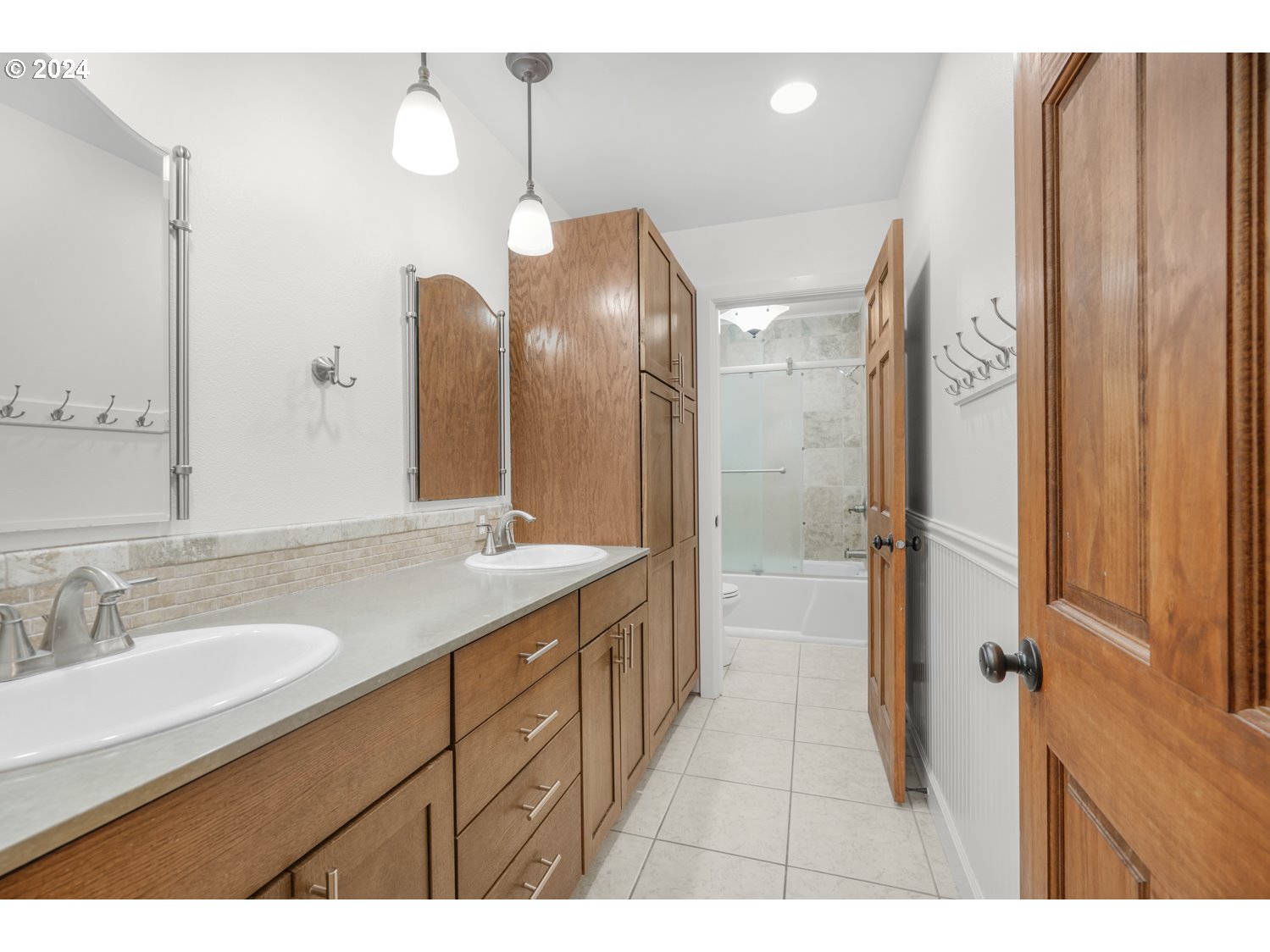 311 Washington Street Lyle, WA 98635 - Photo 23 of 29 a spacious bathroom with a granite countertop sink a mirror and a shower