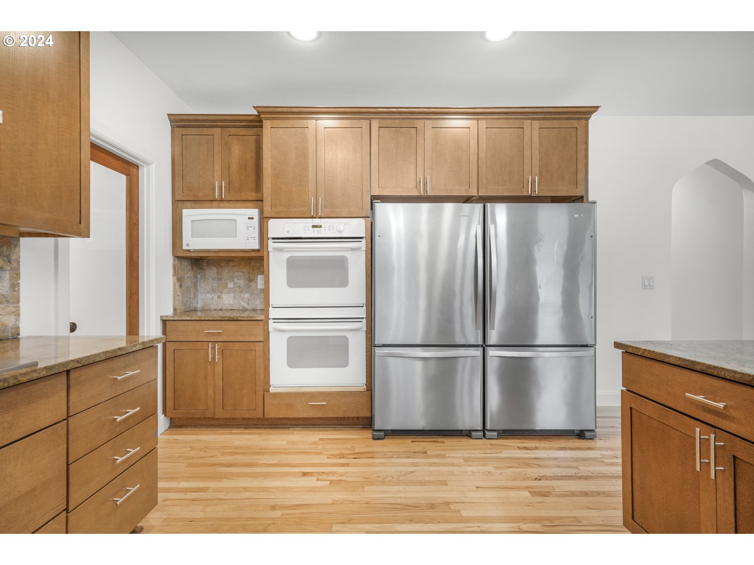 311 Washington Street Lyle, WA 98635 - Photo 9 of 29 a kitchen with kitchen island a counter top space wooden floor and stainless steel appliances