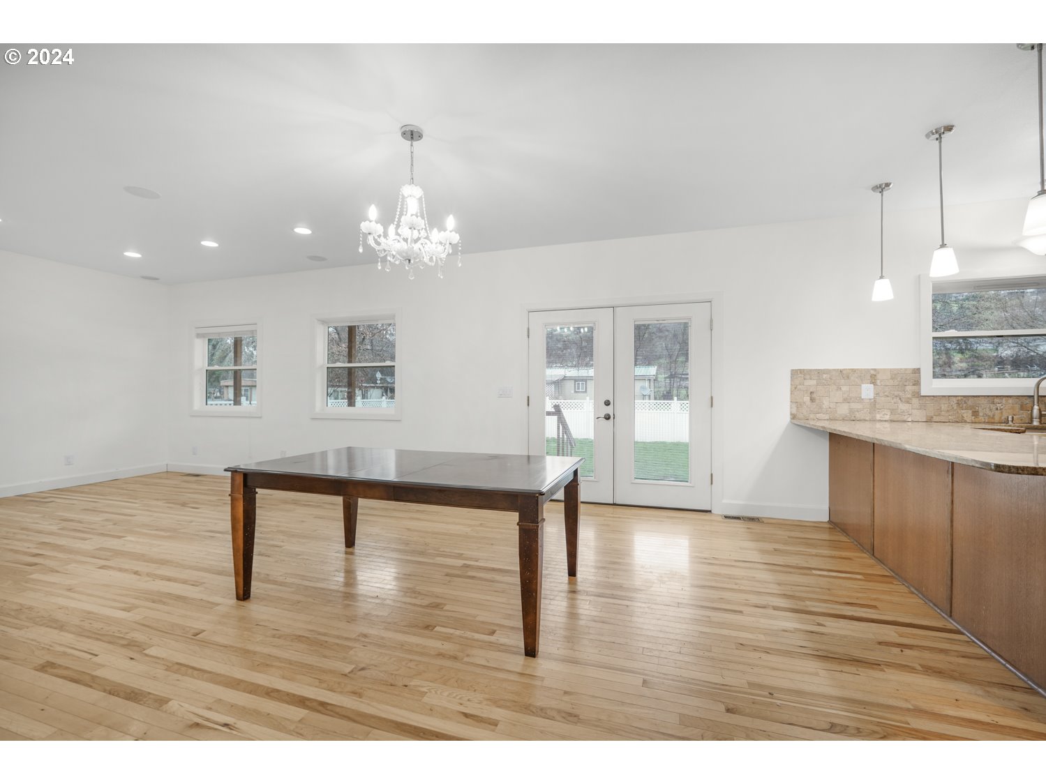 311 Washington Street Lyle, WA 98635 - Photo 10 of 29 a view of a living room and kitchen with wooden floor