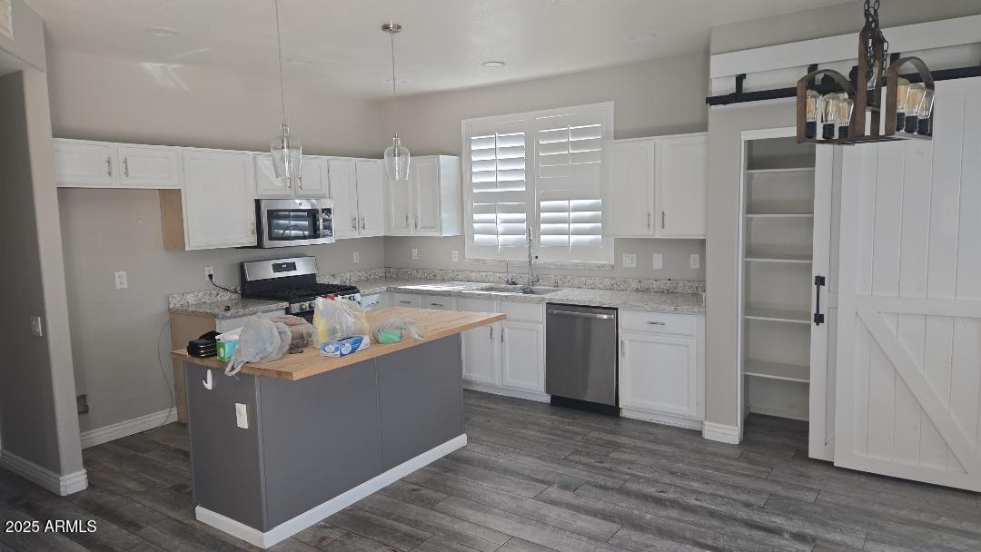 854 South Comanche Court Chandler, AZ 85224 - Photo 3 of 6 a kitchen with stainless steel appliances granite countertop a refrigerator a sink dishwasher a stove and white cabinets with wooden floor