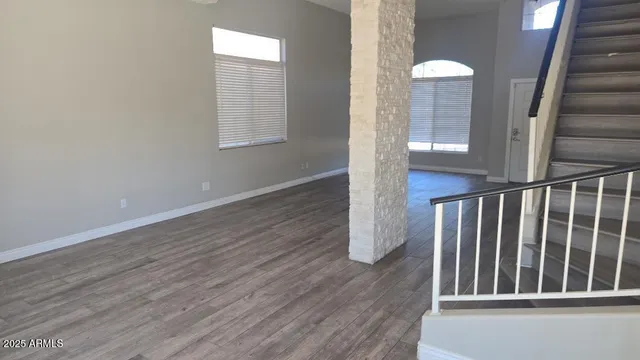 an entryway in wooden floor hall witha front door