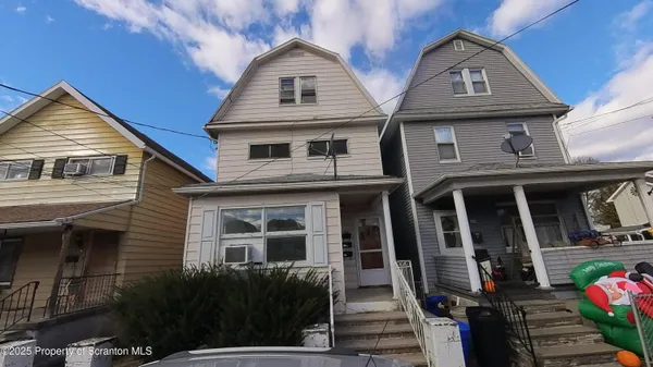 a front view of a house with many windows