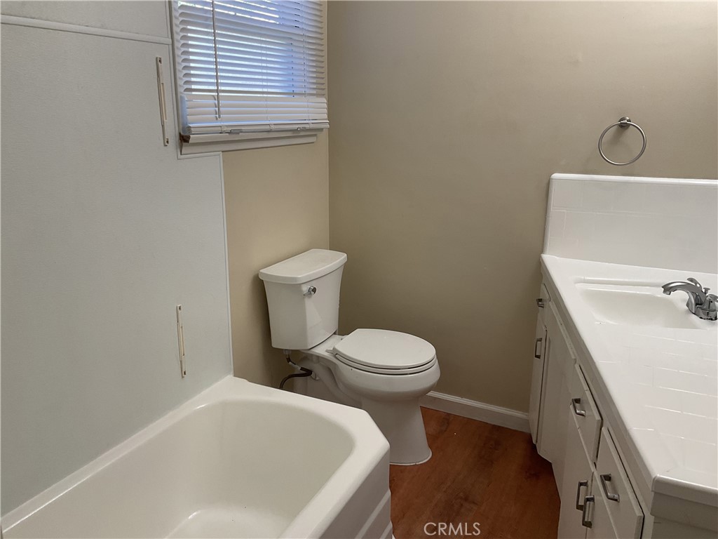 7570 Delaware Street Riverside, CA 92504 - Photo 13 of 21 a white toilet sitting next to a bathroom sink