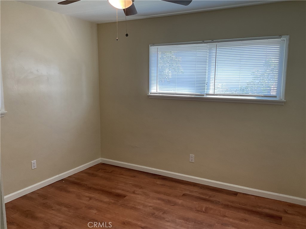 7570 Delaware Street Riverside, CA 92504 - Photo 14 of 21 a view of an empty room with wooden floor and a window