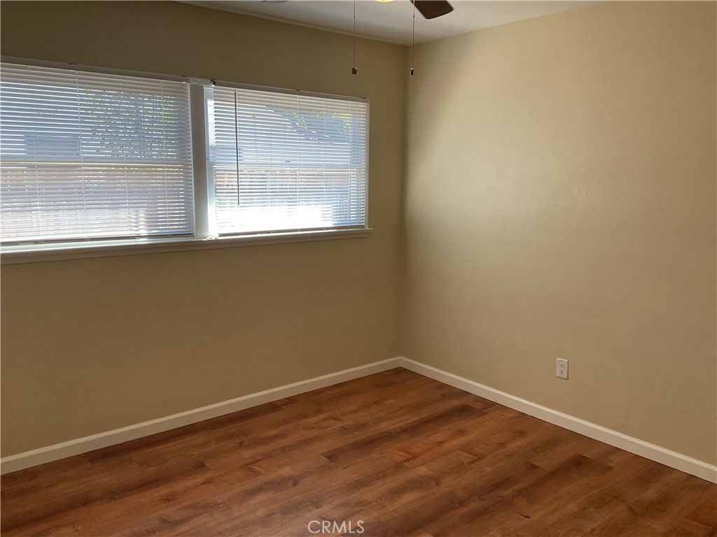 7570 Delaware Street Riverside, CA 92504 - Photo 15 of 21 an empty room with wooden floor and windows