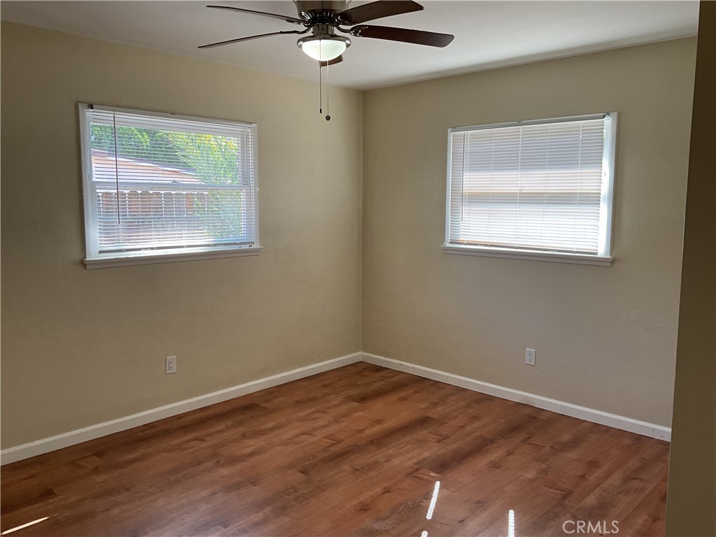 7570 Delaware Street Riverside, CA 92504 - Photo 16 of 21 a view of an empty room with wooden floor and a window