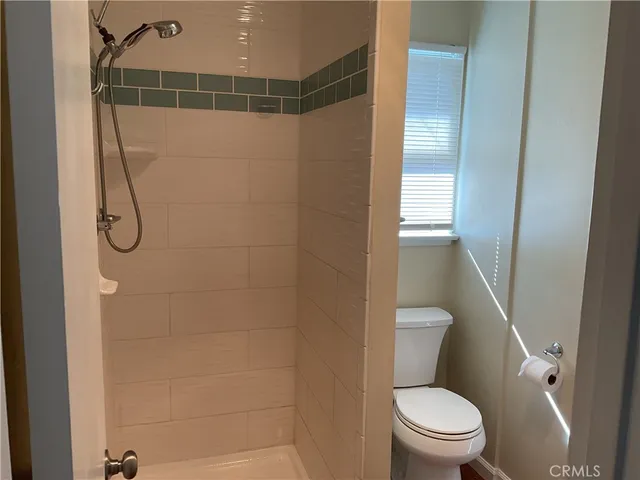 a bathroom with a toilet and shower