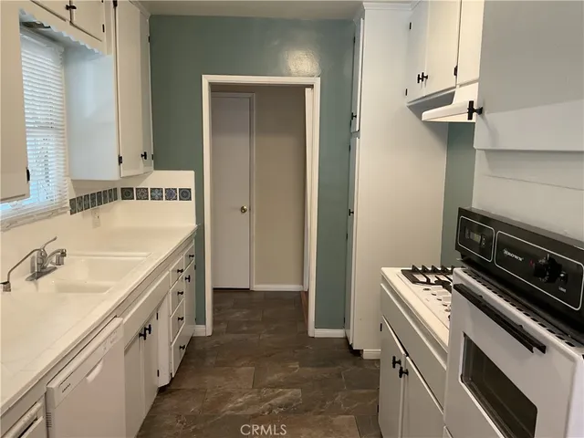 a kitchen with a sink stove and cabinets
