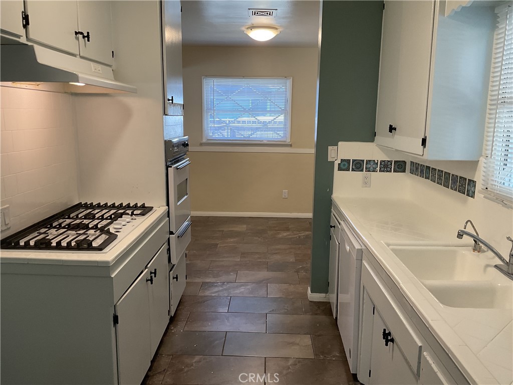 7570 Delaware Street Riverside, CA 92504 - Photo 5 of 21 a kitchen with a sink stove and refrigerator