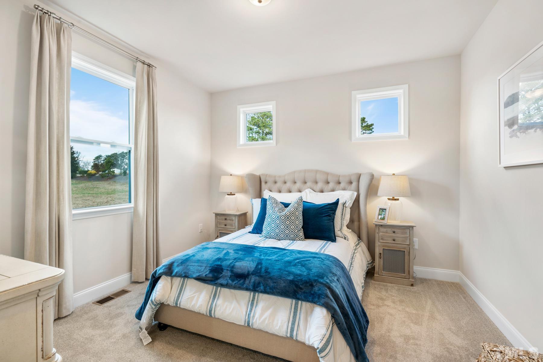 197 Karlov Road Garner, NC 27529 - Photo 27 of 48 a bedroom with a bed and a window