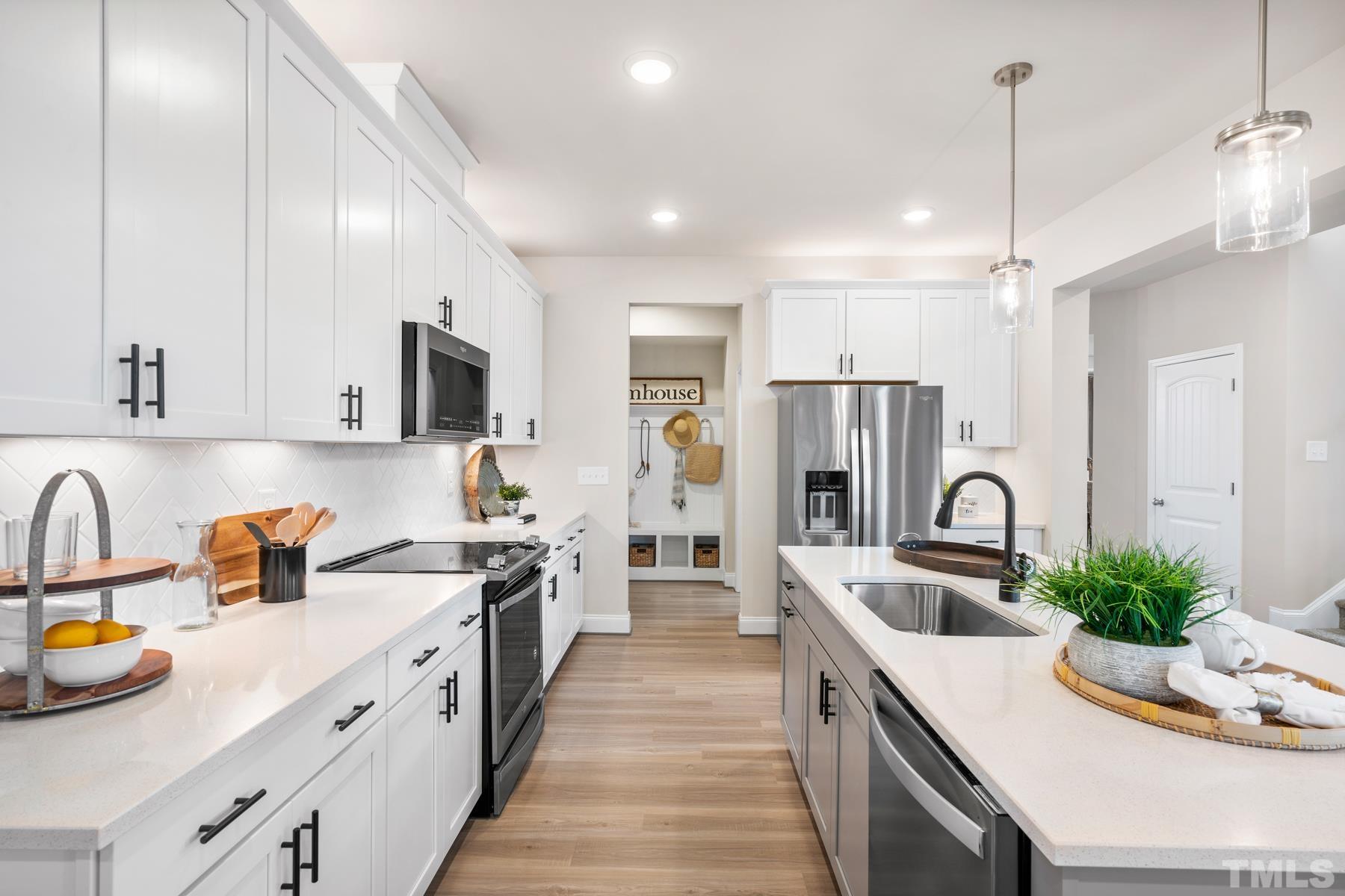 197 Karlov Road Garner, NC 27529 - Photo 5 of 48 a kitchen with stainless steel appliances kitchen island granite countertop a sink and refrigerator