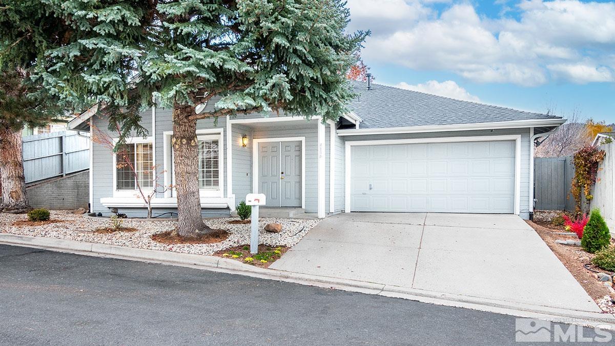 6209 Alpine Meadows Road Reno, NV 89519 - Photo 1 of 23 a front view of a house with basket ball court and outdoor seating