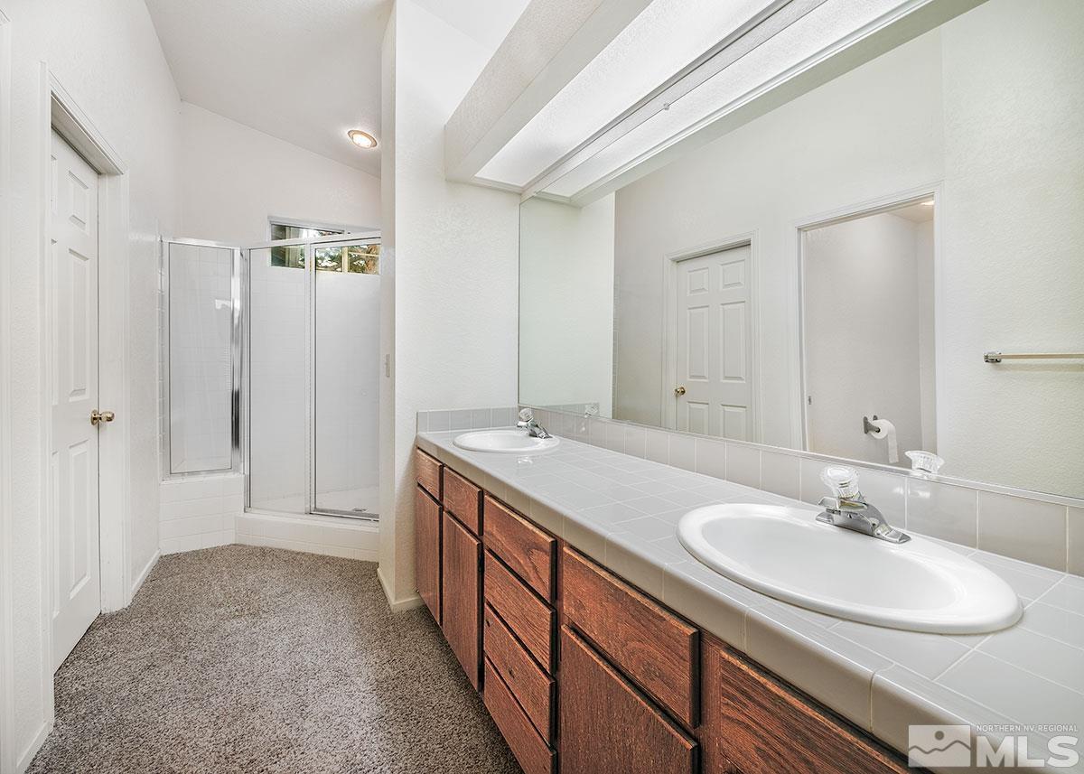 6209 Alpine Meadows Road Reno, NV 89519 - Photo 14 of 23 a bathroom with a sink double vanity and a mirror