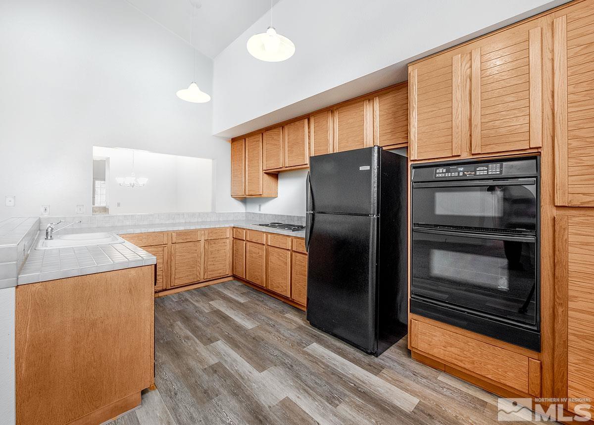 6209 Alpine Meadows Road Reno, NV 89519 - Photo 3 of 23 a kitchen with a refrigerator and a sink