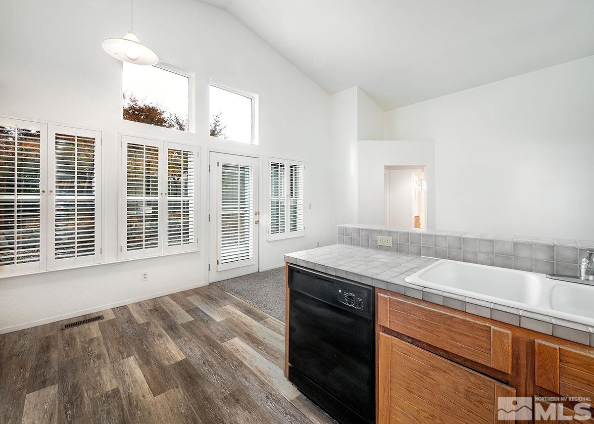 6209 Alpine Meadows Road Reno, NV 89519 - Photo 4 of 23 a kitchen with granite countertop a sink and a stove