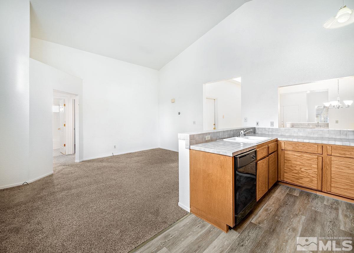 6209 Alpine Meadows Road Reno, NV 89519 - Photo 5 of 23 a kitchen with stainless steel appliances granite countertop a sink and a stove top oven
