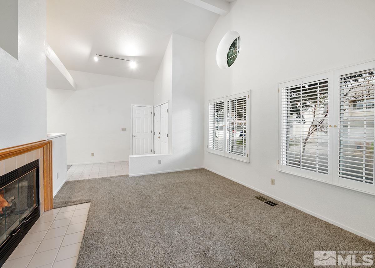 6209 Alpine Meadows Road Reno, NV 89519 - Photo 9 of 23 a view of an empty room with a fireplace and a window