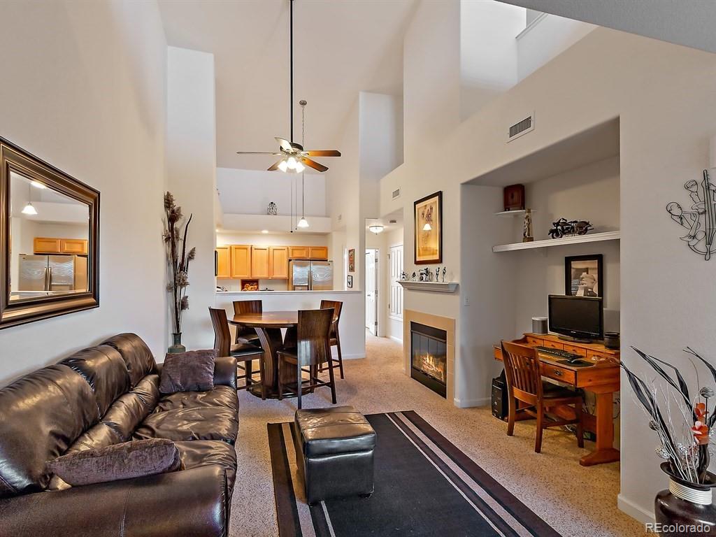 a living room with furniture a dining table and a piano