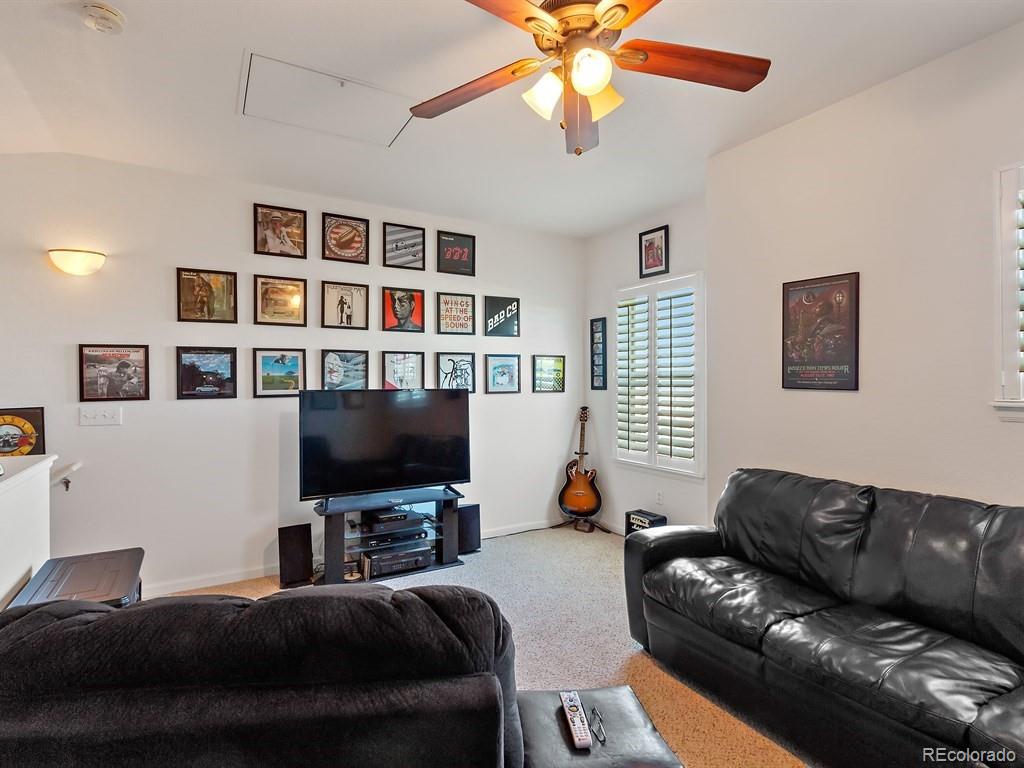 5800 Tower Road, Unit 908 Denver, CO 80249 - Photo 11 of 25 a living room with furniture and a flat screen tv