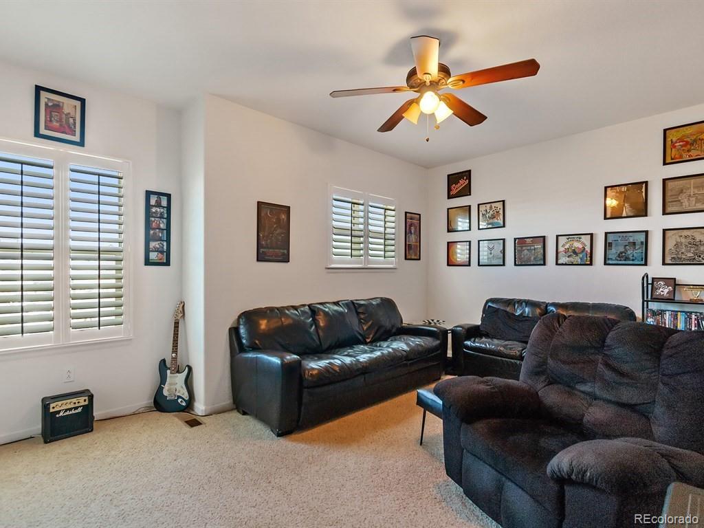 5800 Tower Road, Unit 908 Denver, CO 80249 - Photo 12 of 25 a living room with furniture and a window