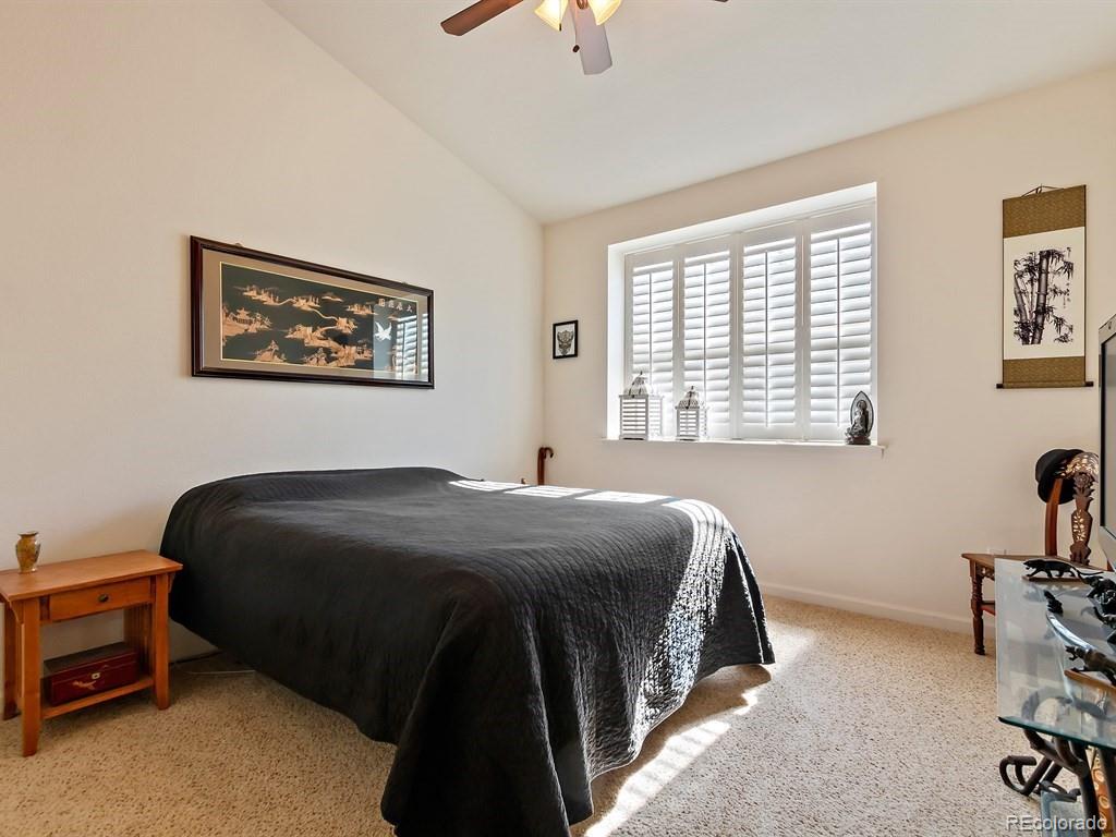 5800 Tower Road, Unit 908 Denver, CO 80249 - Photo 13 of 25 a bedroom with a bed and a chandelier