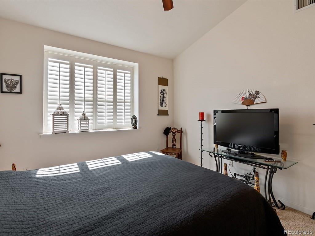 5800 Tower Road, Unit 908 Denver, CO 80249 - Photo 14 of 25 a bedroom with a bed and a flat screen tv