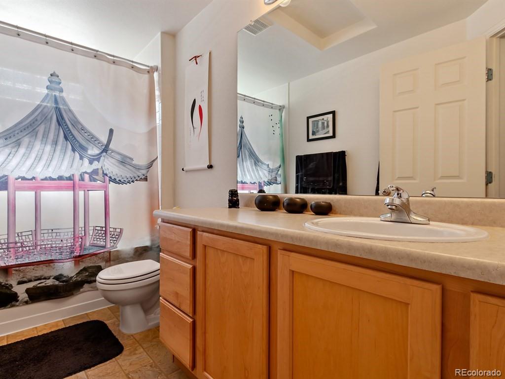 5800 Tower Road, Unit 908 Denver, CO 80249 - Photo 15 of 25 a bathroom with a double vanity sink mirror and toilet