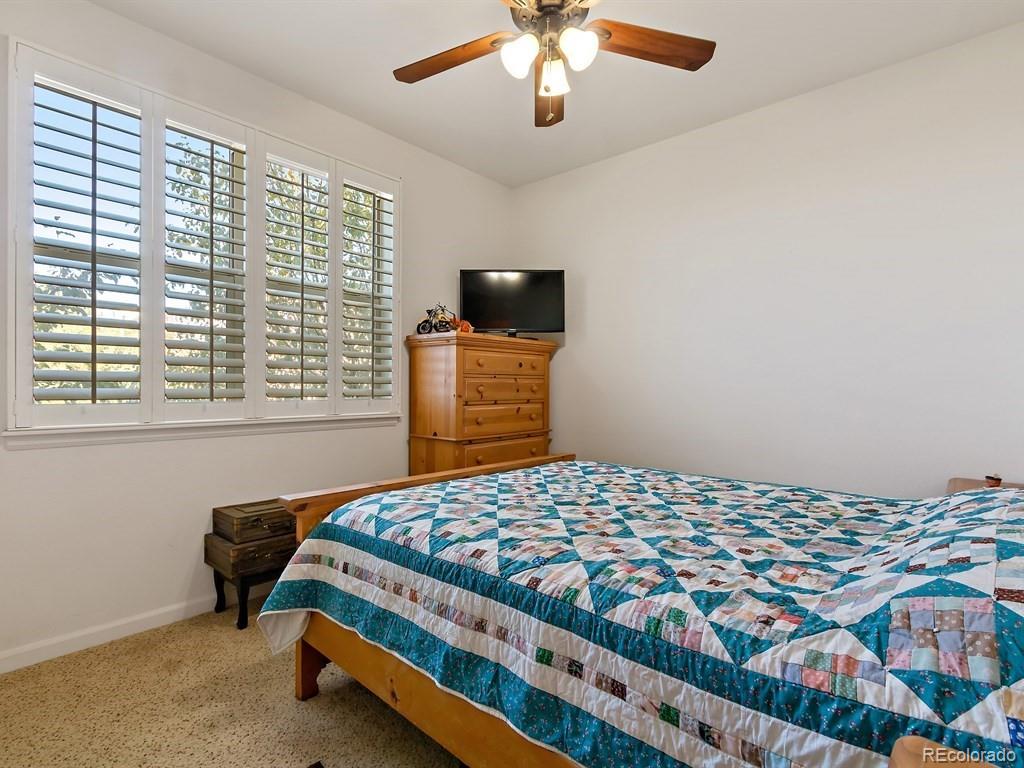5800 Tower Road, Unit 908 Denver, CO 80249 - Photo 16 of 25 a bedroom with a bed and a flat screen tv